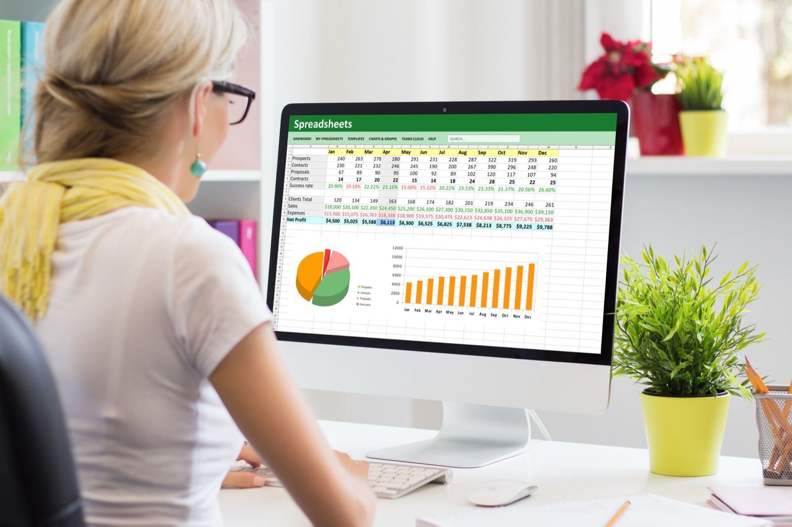 Billing specialist reviewing collections, charts, and claims data on a computer, showing the reporting visibility MMSM brings Michigan providers